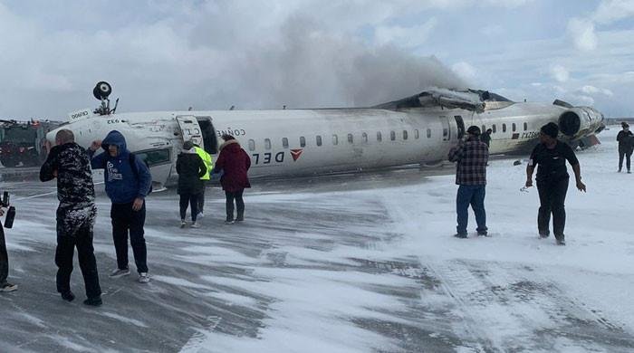 Eight injured as landing plane flips at Toronto airport Eight injured as landing plane flips at Toronto airport
